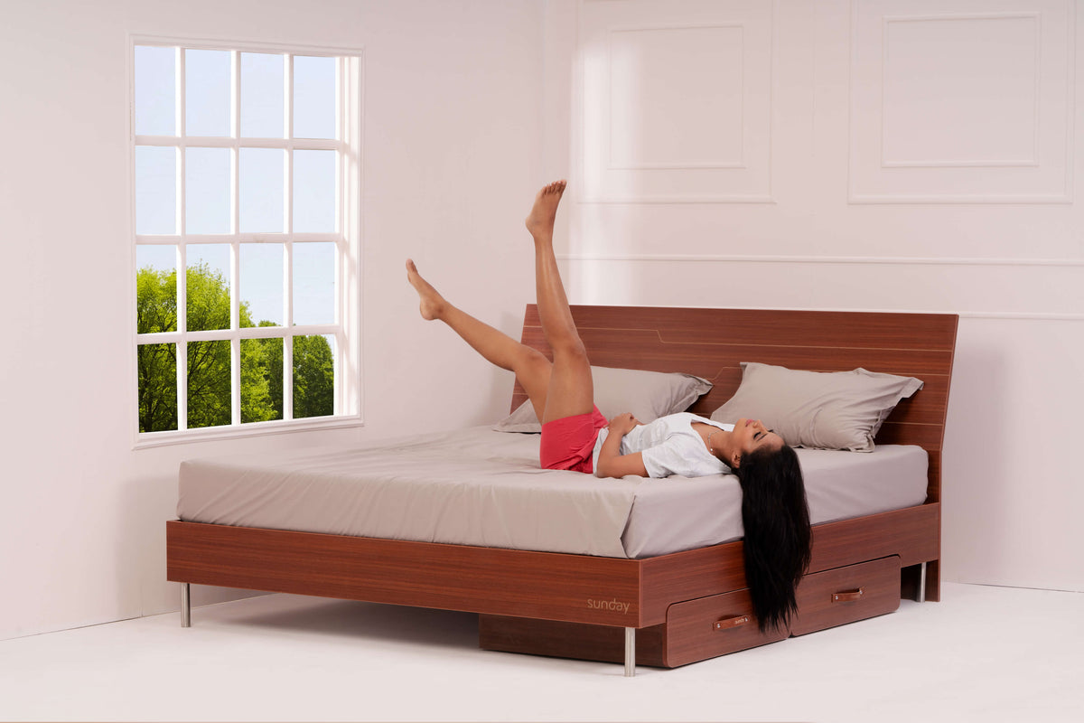 A woman relaxing on the Sunday Tilt Bed